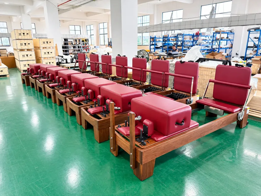 Burgundy Reformer Benches In A Bright Workshop