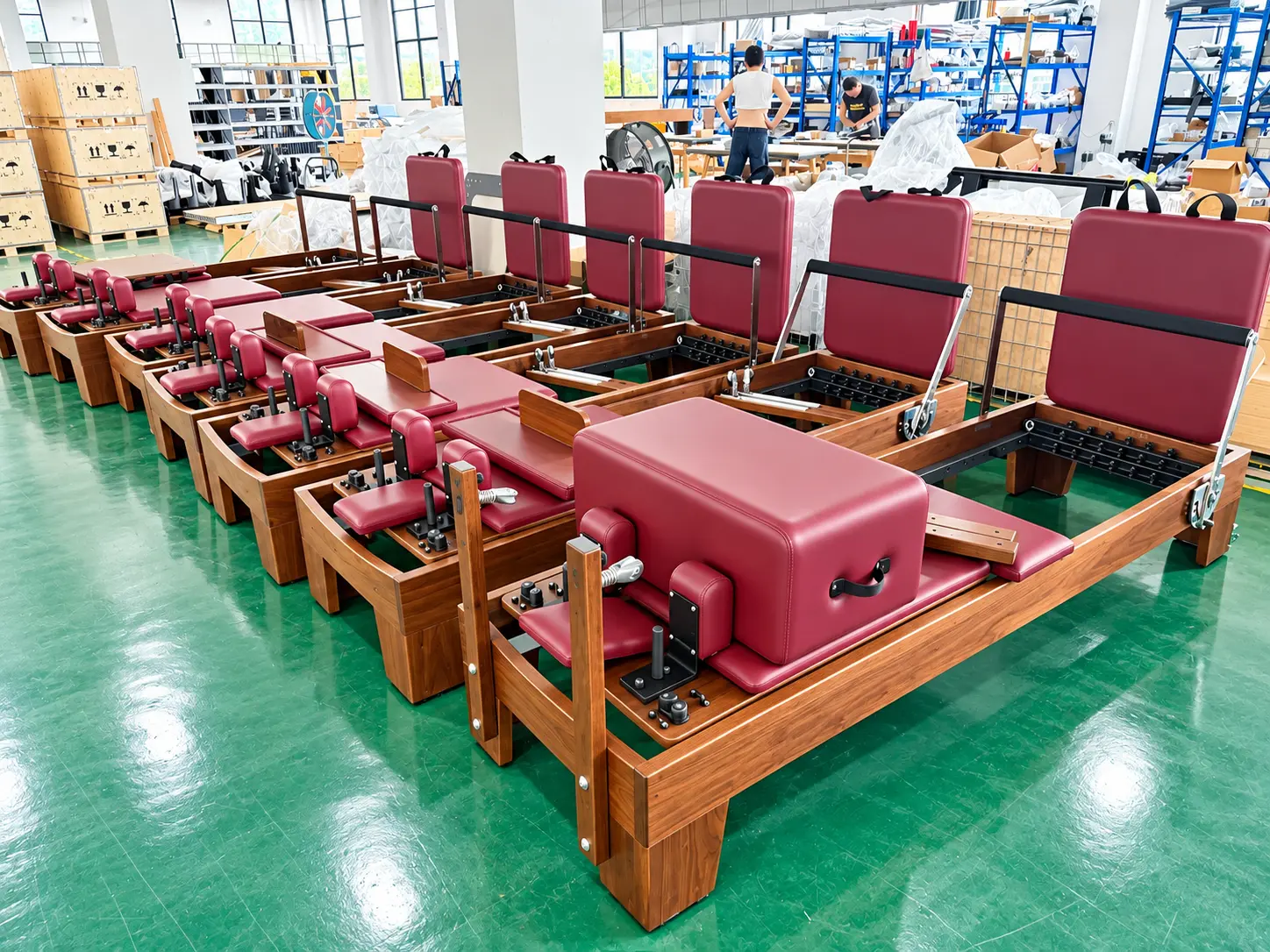Walnut Pilates Reformers In A Bright Workshop